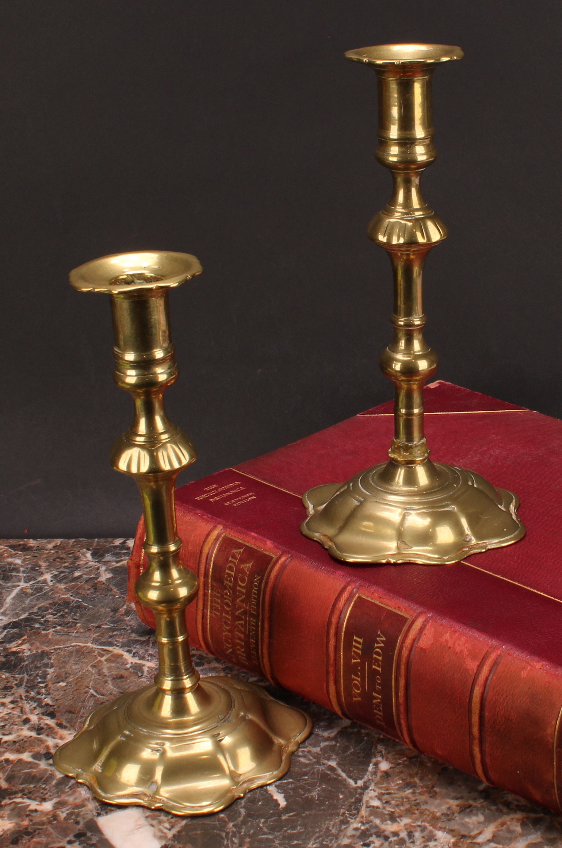 A pair of George II brass candlesticks, knopped pillars, domed shaped bases, 24cm high, c.1745