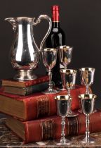 An Irish silver wine service, comprising a baluster jug and six goblets, gilt interiors, the jug