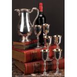 An Irish silver wine service, comprising a baluster jug and six goblets, gilt interiors, the jug