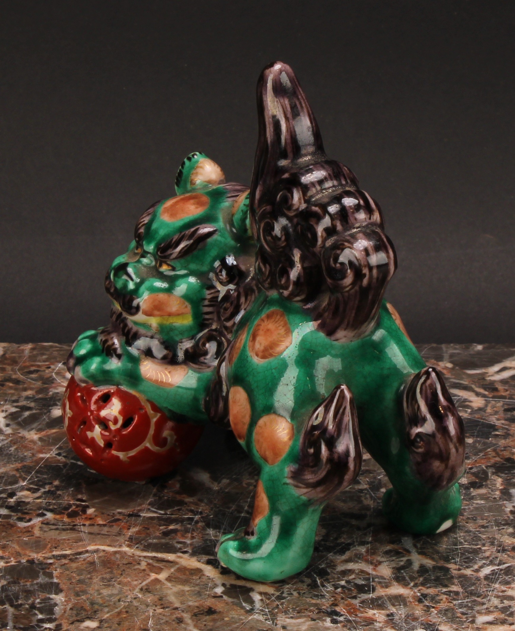 A Japanese porcelain model, of a temple lion, glazed in monochrome tones, 12.5cm wide, lacquer - Image 4 of 5