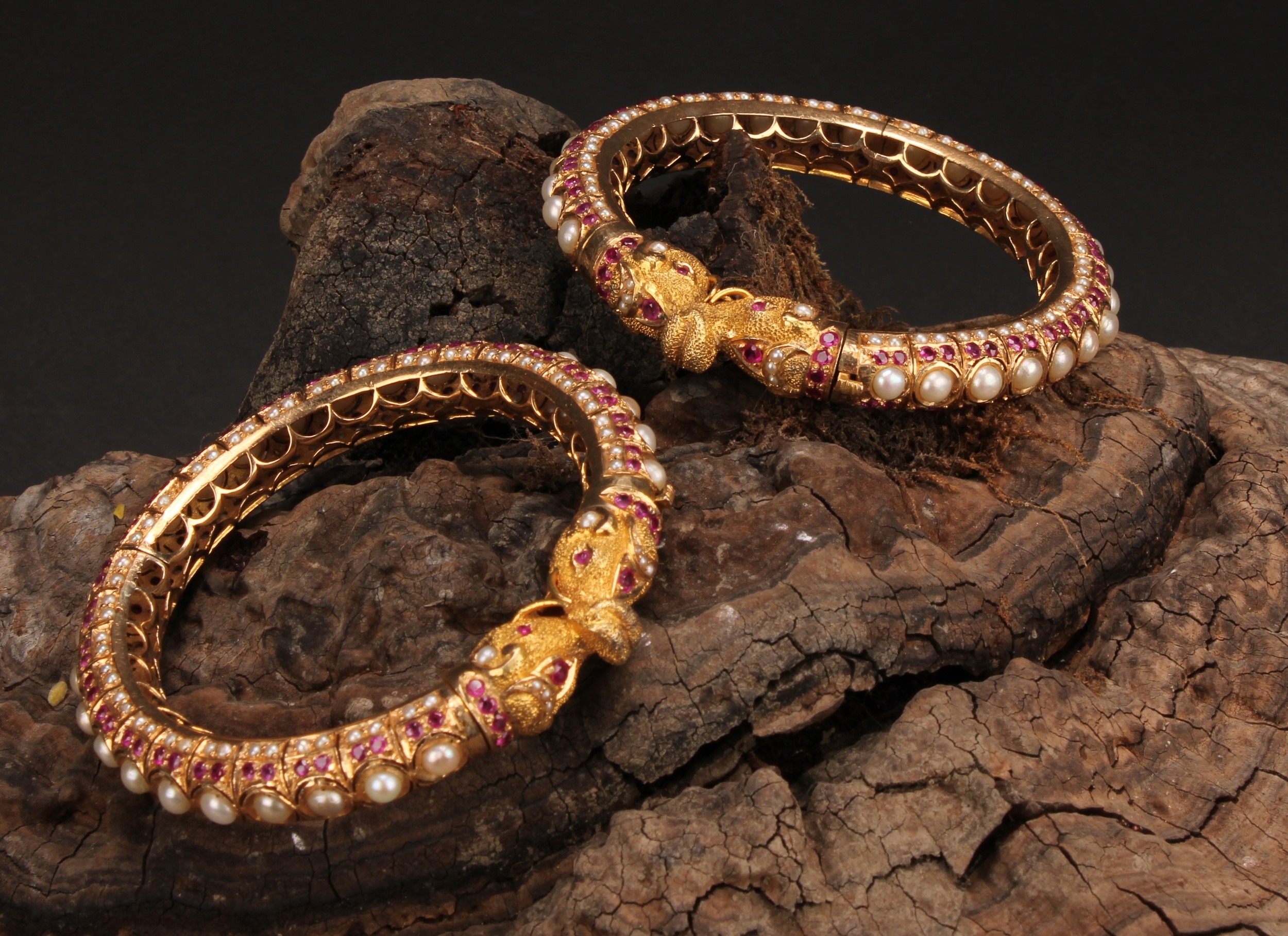 A pair of high carat gold coloured metal Indian wedding bangles, the whole inlaid with pearls