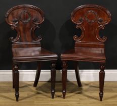 A pair of George IV mahogany hall chairs, in the manner of Gillows of Lancaster and London, each