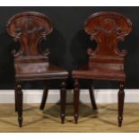 A pair of George IV mahogany hall chairs, in the manner of Gillows of Lancaster and London, each