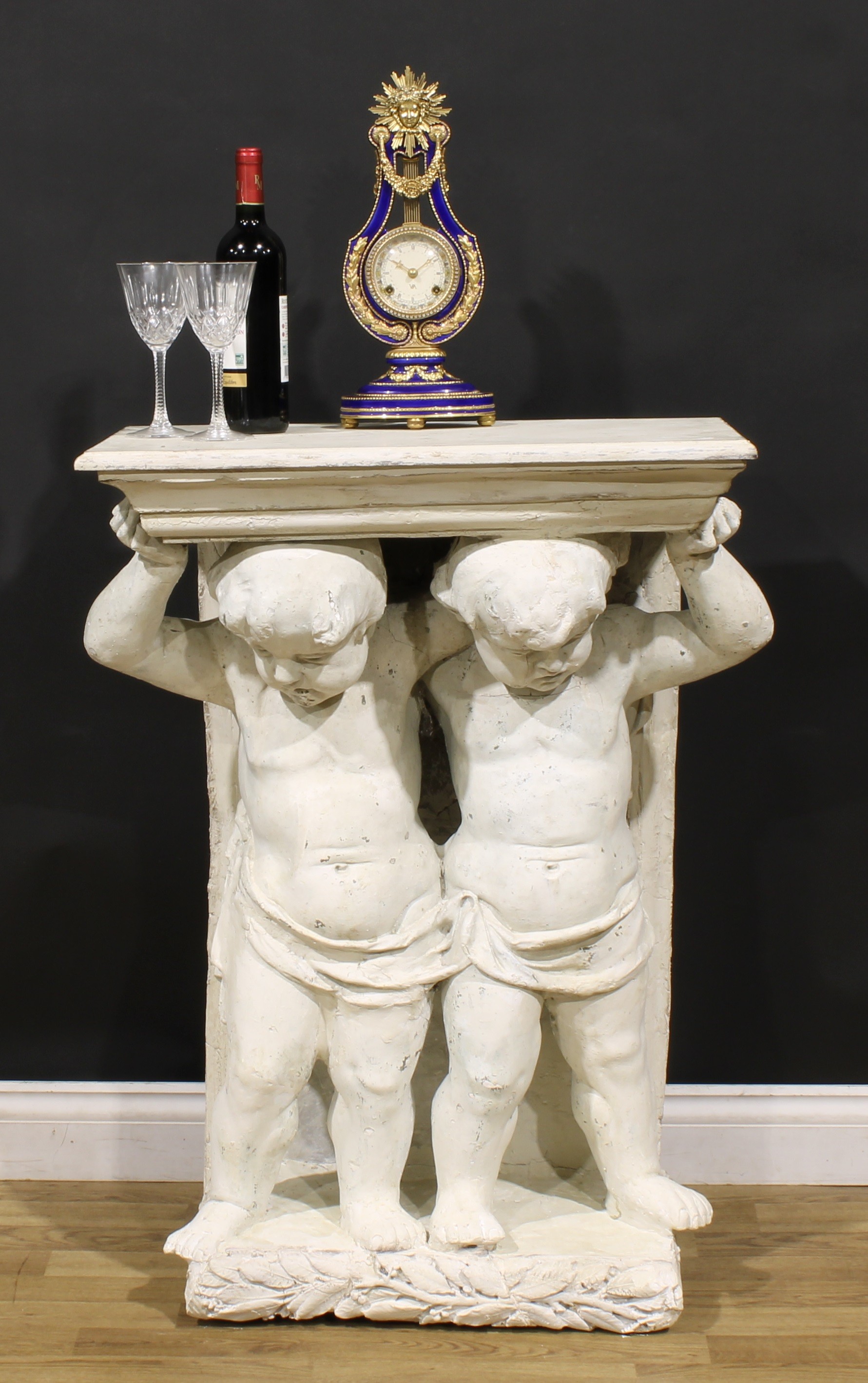 A neoclassical painted plaster and softwood figural pier table, rectangular plateau with moulded
