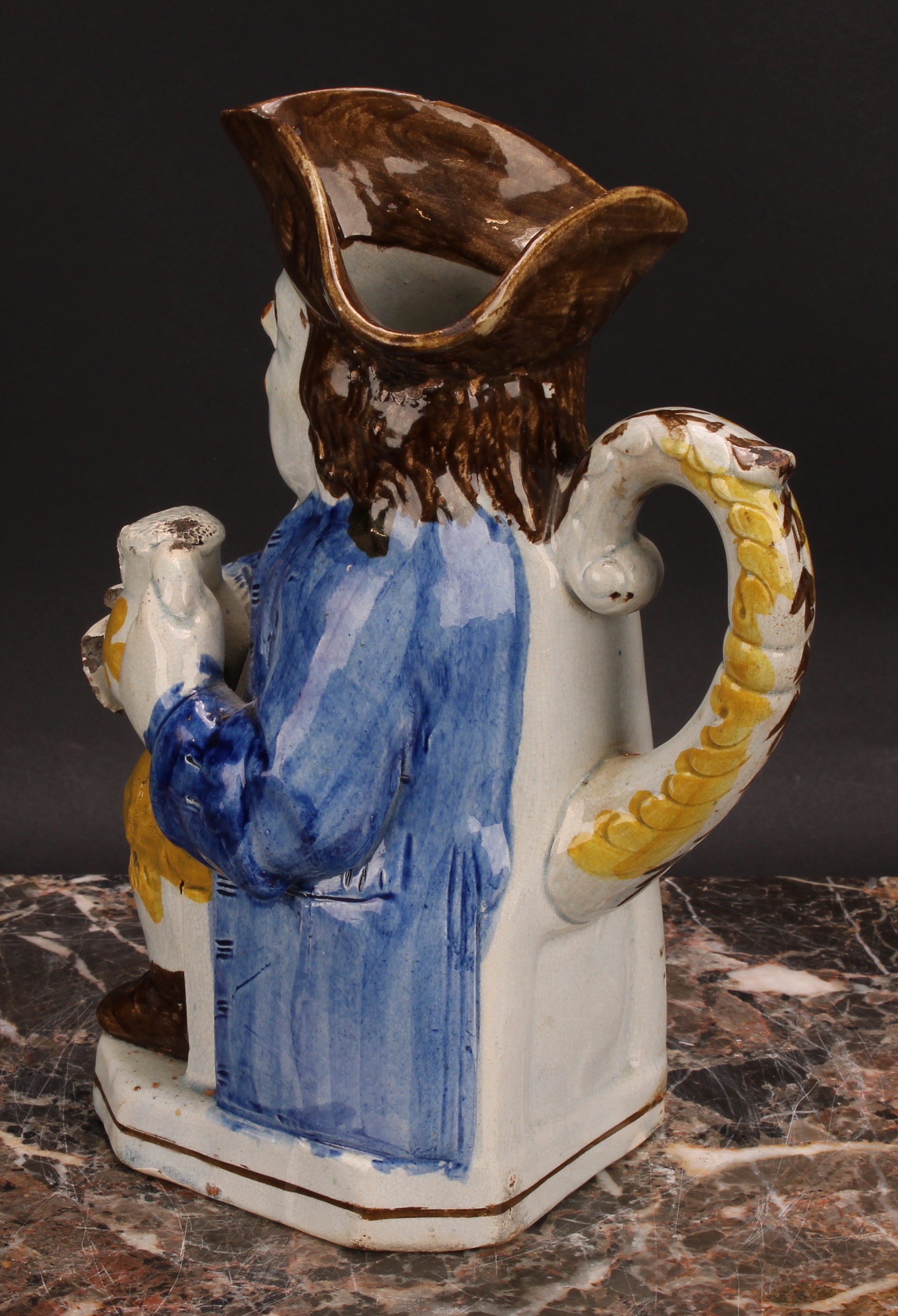 An early 19th century Prattware Toby jug, seated holding a jug of foaming ale, painted in polychrome - Image 4 of 5