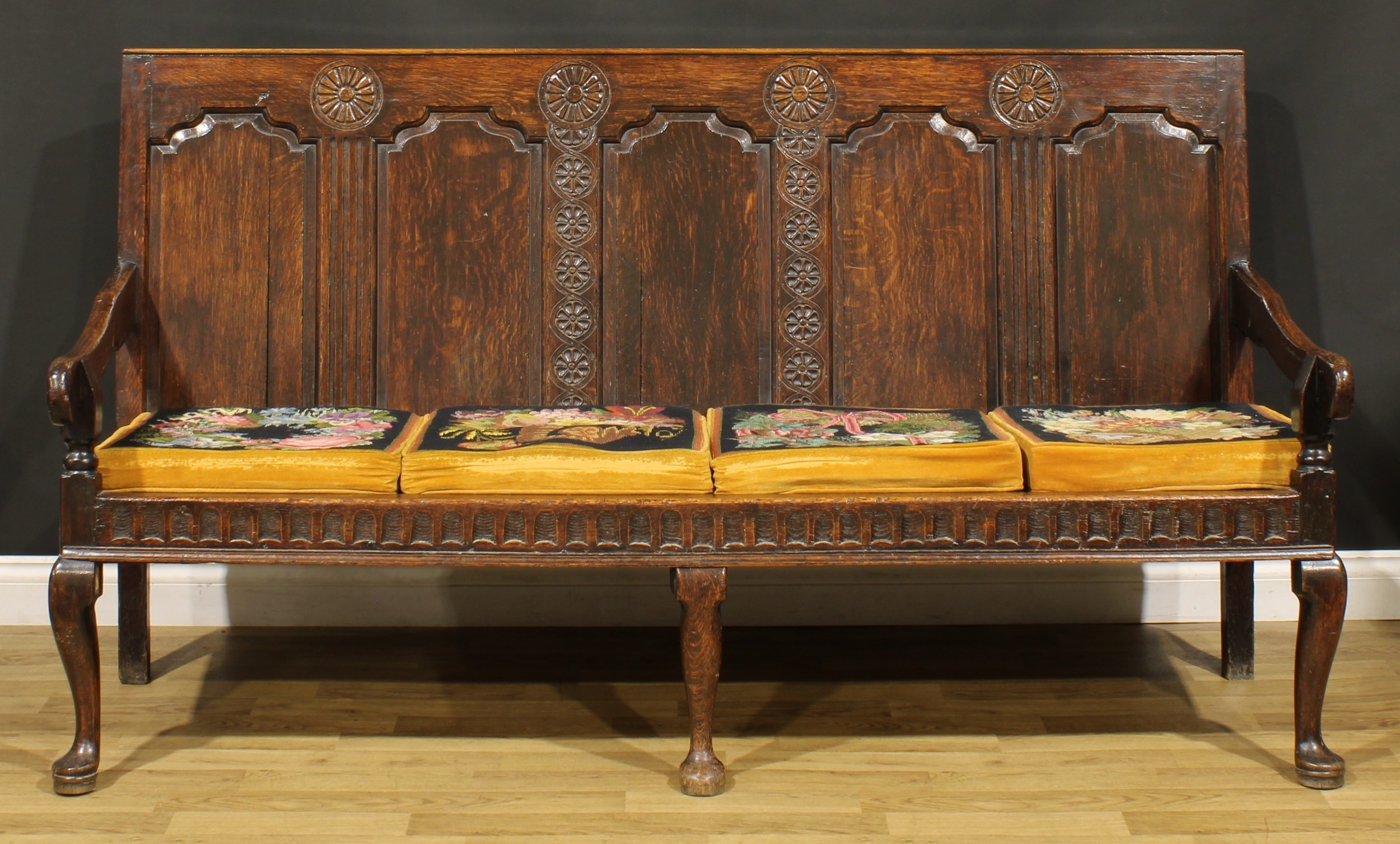 A 17th century design oak settle, rectangular back with five raised and fielded panels, nulled