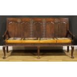 A 17th century design oak settle, rectangular back with five raised and fielded panels, nulled