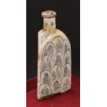 A Middle-Eastern tin-glazed earthenware triform flask, decorated with flowers and layered lotus,