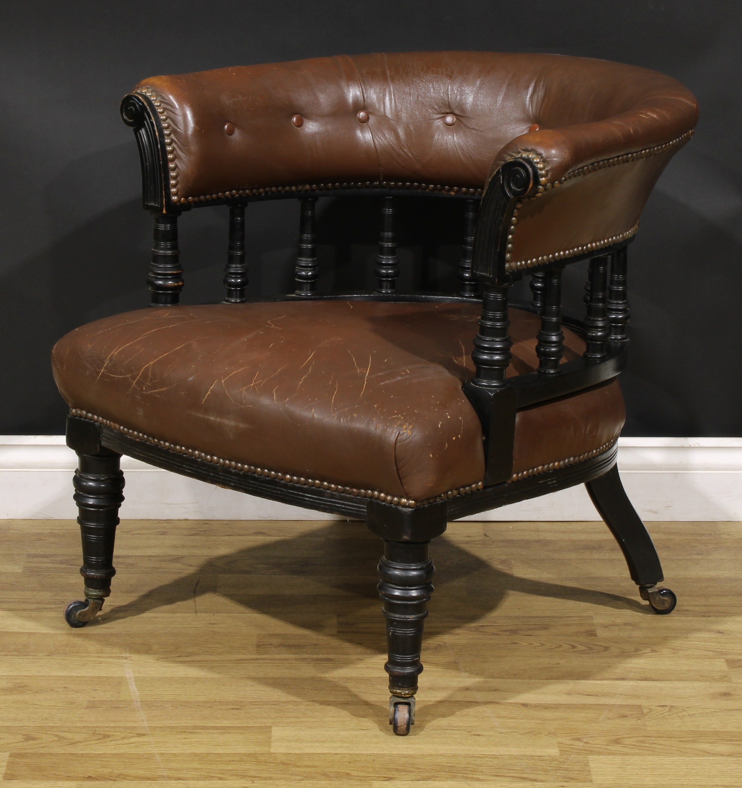 A late Victorian ebonised club or library chair, stuffed-over upholstery, turned forelegs, 69cm - Image 3 of 4