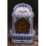 A late 19th century porcelain mantel timepiece, in the Delft manner, 7.5cm circular dial inscribed