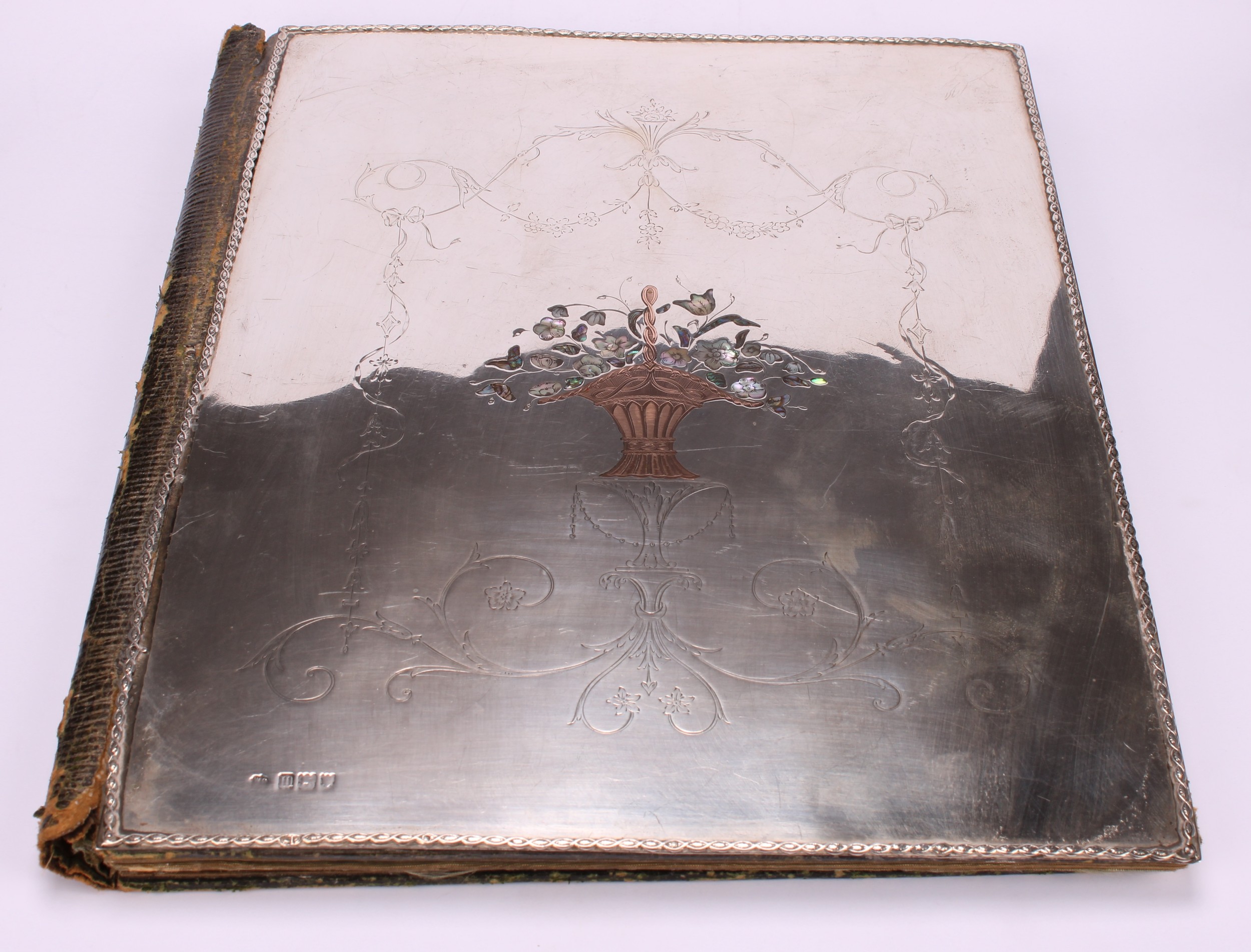 An Edwardian silver and pique desk blotter, inlaid in abalone shell and gold coloured metal with a