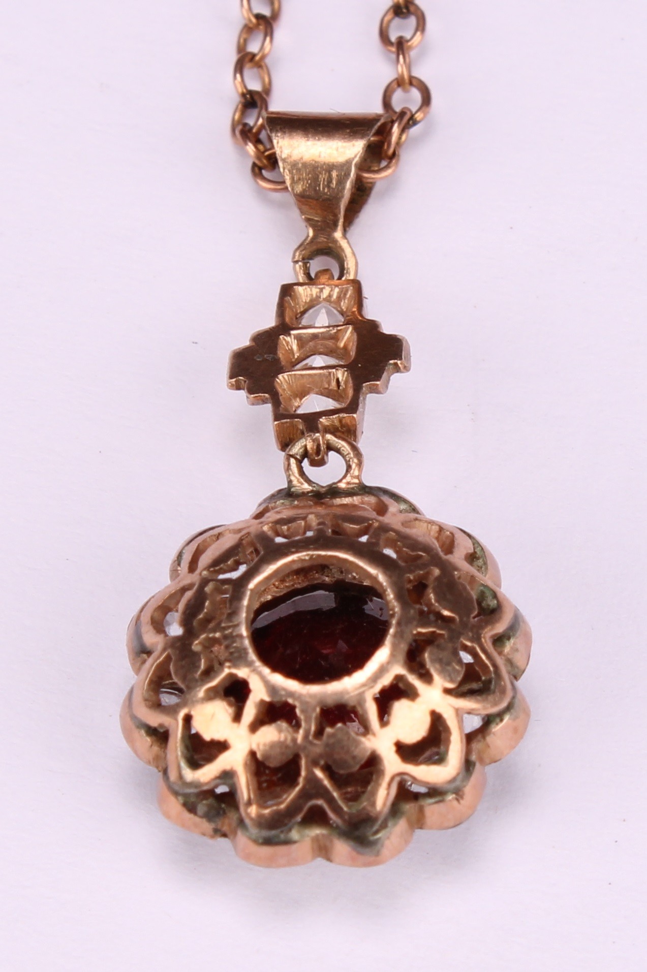 A red garnet and white stone cluster pendant, rose metal mount, suspended from a 9ct gold chain, - Image 5 of 5