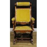 An unusual 19th century American walnut rocking chair, adjustable headrest, shaped arms, reeded