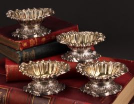 A set of four George IV cast silver Rococo salts, gilt interiors, 10.5cm wide, S C Younge & Co,