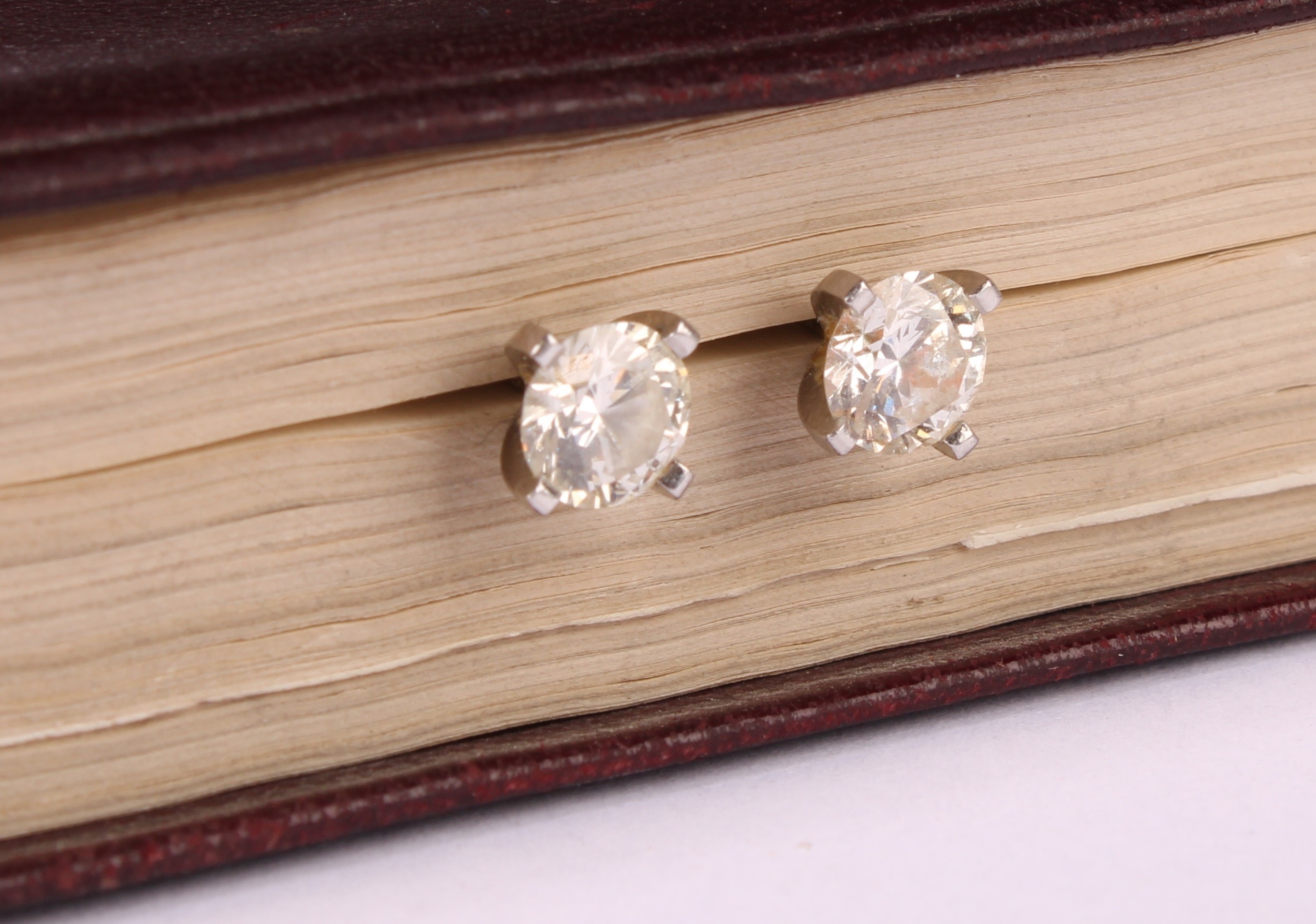 A pair of diamond stud earrings, the round brilliant cut stones claw set, platinum mounted, 1.7ct