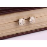 A pair of diamond stud earrings, the round brilliant cut stones claw set, platinum mounted, 1.7ct
