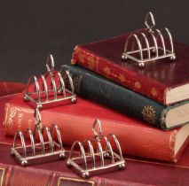 A set of four George V silver miniature five bar toast racks, 5cm long, Adie Brothers Ltd,