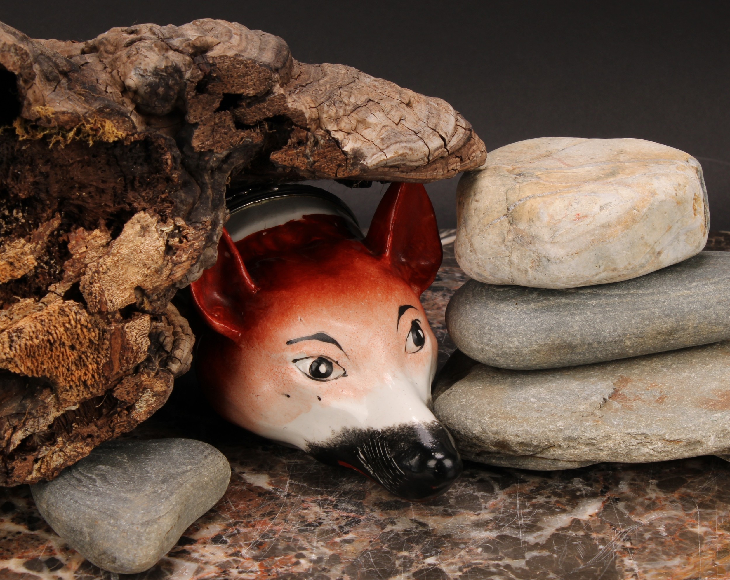 A Staffordshire pottery novelty stirrup cup, modelled as a fox mask, naturalistically painted,