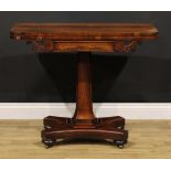 A William IV rosewood card table, rounded rectangular folding top above a frieze carved with leafy