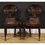 A pair of Post-Regency mahogany hall chairs, in the manner of Gillows of Lancaster and London,