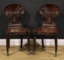 A pair of Post-Regency mahogany hall chairs, in the manner of Gillows of Lancaster and London,