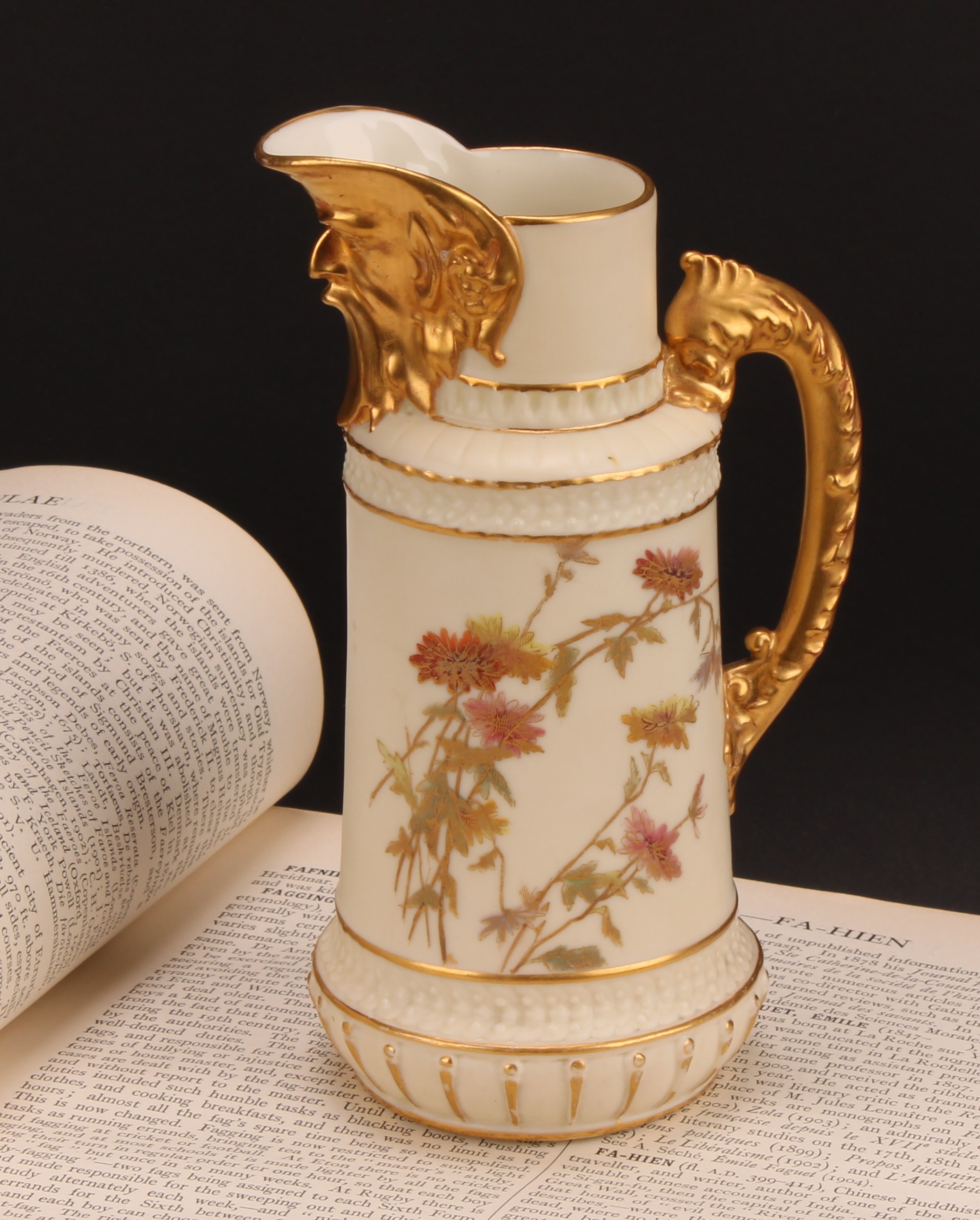 A Royal Worcester jug, decorated in the Aesthetic manner with flowers and foliage in muted tones,