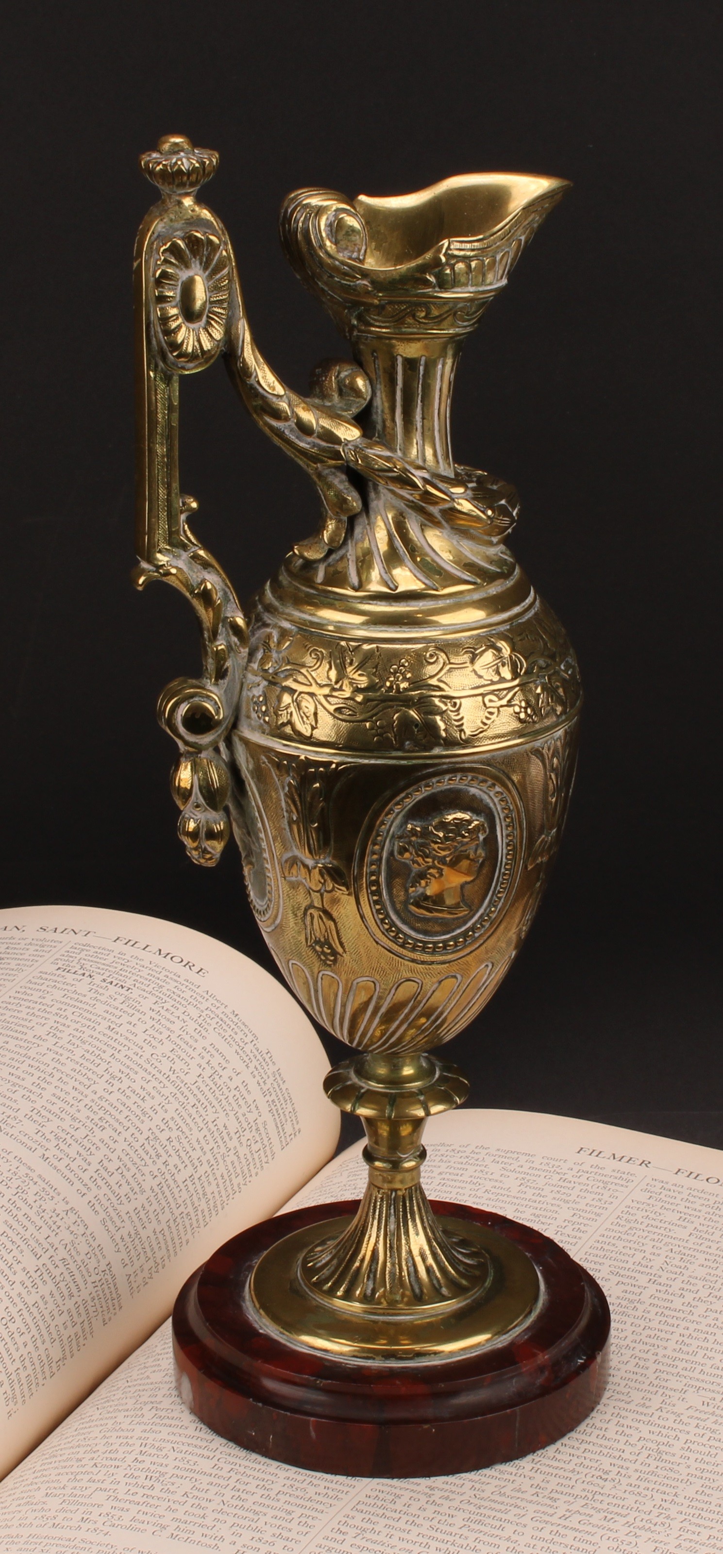 A 19th century Grand Tour bronze ewer, probably French, cast with portraits and fruiting vine,