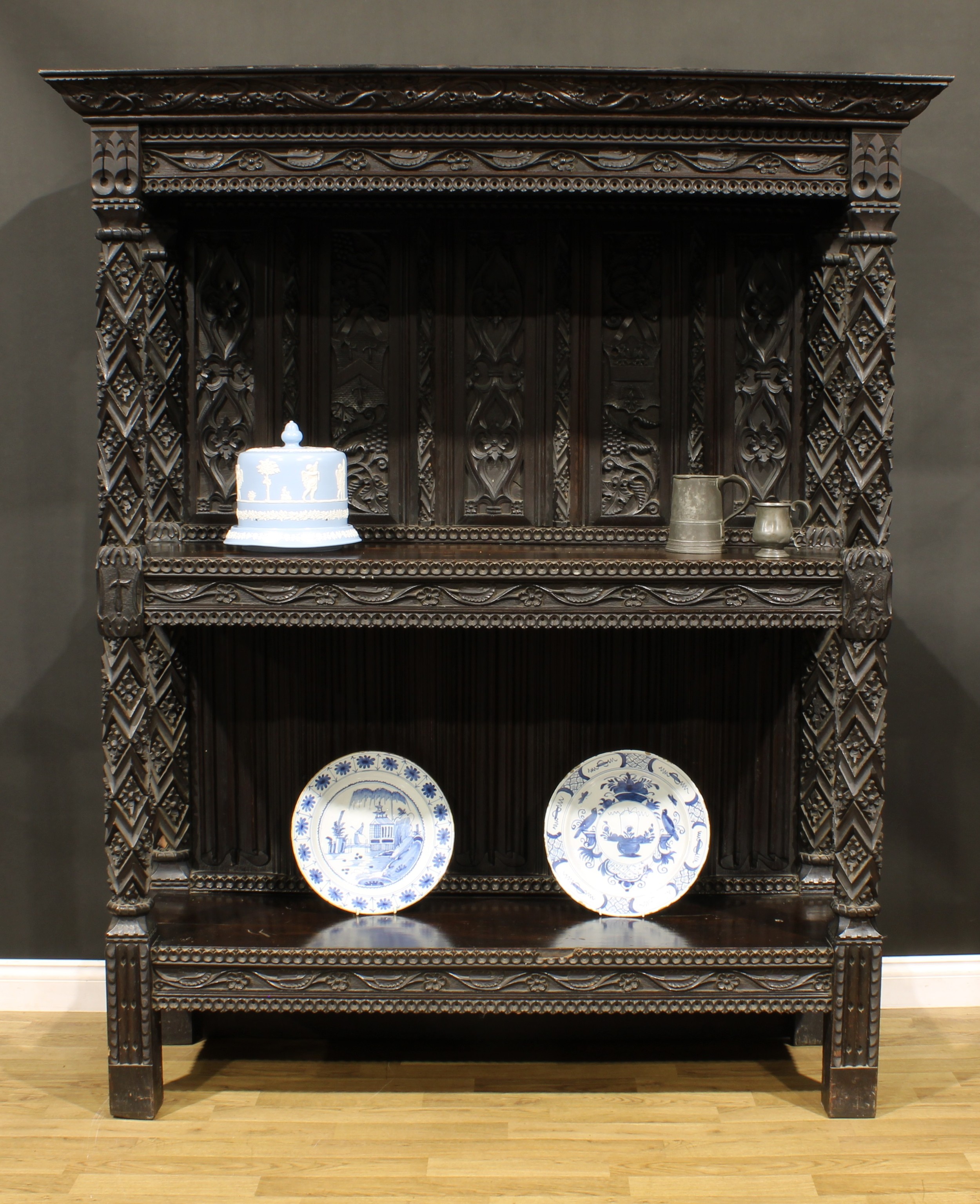 A 19th century oak buffet or cup-board, in the manner of George Shaw, outswept cornice above two