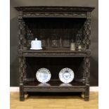 A 19th century oak buffet or cup-board, in the manner of George Shaw, outswept cornice above two