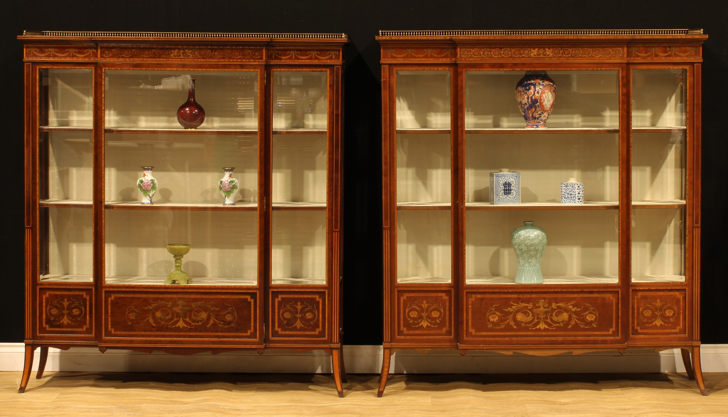 A near pair of Sheraton Revival satinwood crossbanded mahogany and marquetry break-centre display