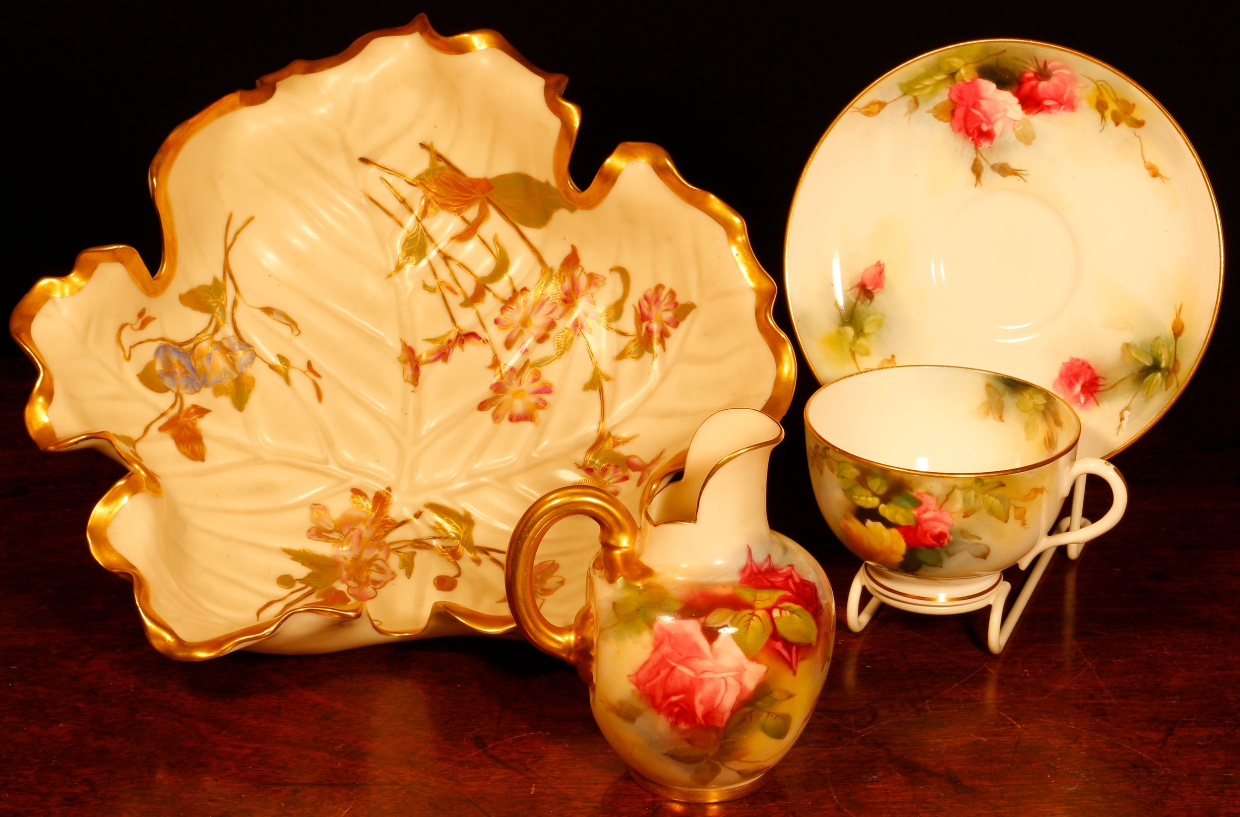 A Royal Worcester flat back ovoid jug, painted with Hadley style roses on a blush ivory ground, 10.