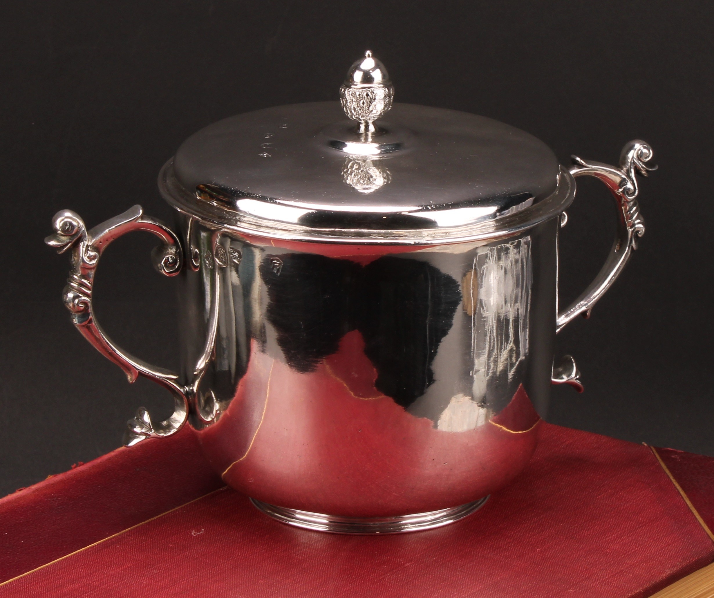 A Charles II silver porringer and cover, acorn finial, scroll handles, engraved armorial, 22.5cm