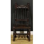 A Charles II oak side chair, curved cresting rail carved with a crown, above a row of spirally-