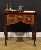 A George III oak lowboy, oversailing top with reentrant forelegs, above three cockbeaded frieze