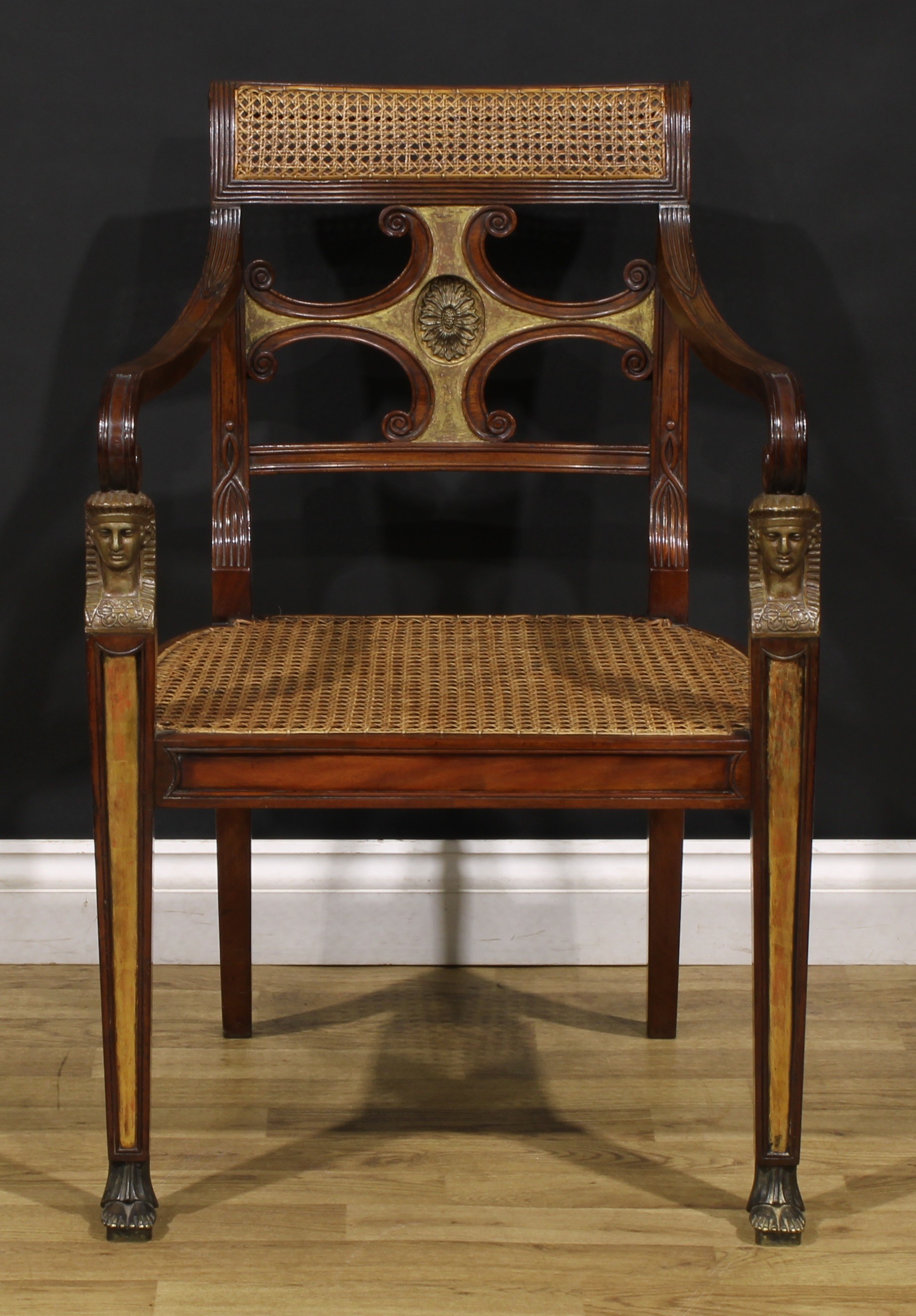 An interesting early 19th century parcel-gilt mahogany elbow chair, reputedly once belonging to