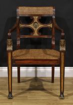 An interesting early 19th century parcel-gilt mahogany elbow chair, reputedly once belonging to