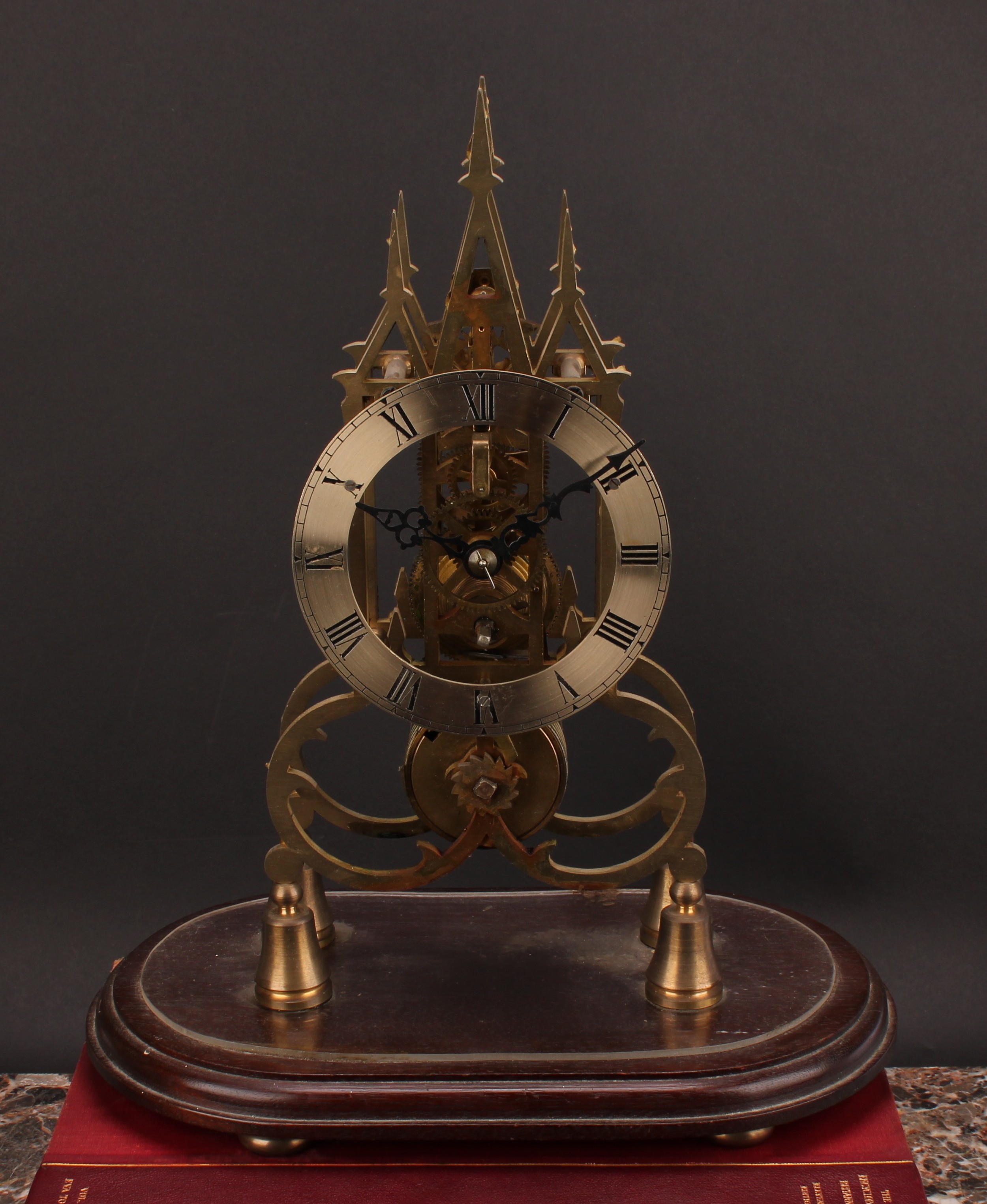 A 19th century style skeleton timepiece, in the Gothic taste, 13cm silvered clock dial inscribed