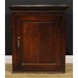 A George III oak wall hanging provision cupboard, raised and fielded panel door enclosing a shelf