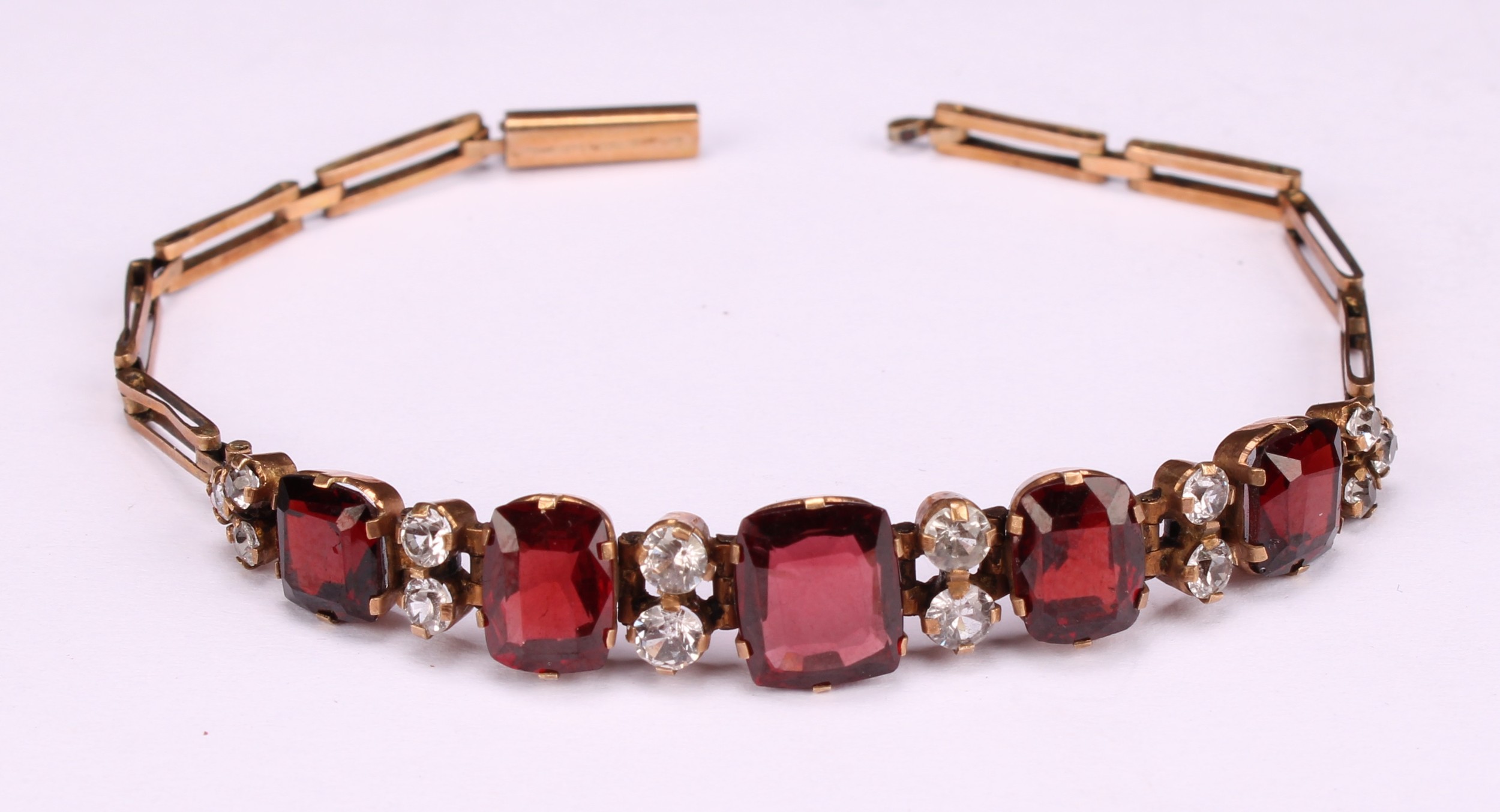 A garnet and diamond bracelet, the five graduated rectangualr mixed cut garnets divided by pairs - Image 3 of 4