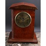 An early 20th century oak officer’s mess type mantel clock, 14.5cm circular brass dial inscribed C.