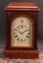 An early 20th century mahogany mantel clock, 15cm arched silvered dial inscribed with Roman