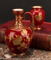 A Royal Crown Derby ovoid ewer, decorated in the Aesthetic manner, with raised gilt flowers on a red