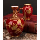 A Royal Crown Derby ovoid ewer, decorated in the Aesthetic manner, with raised gilt flowers on a red