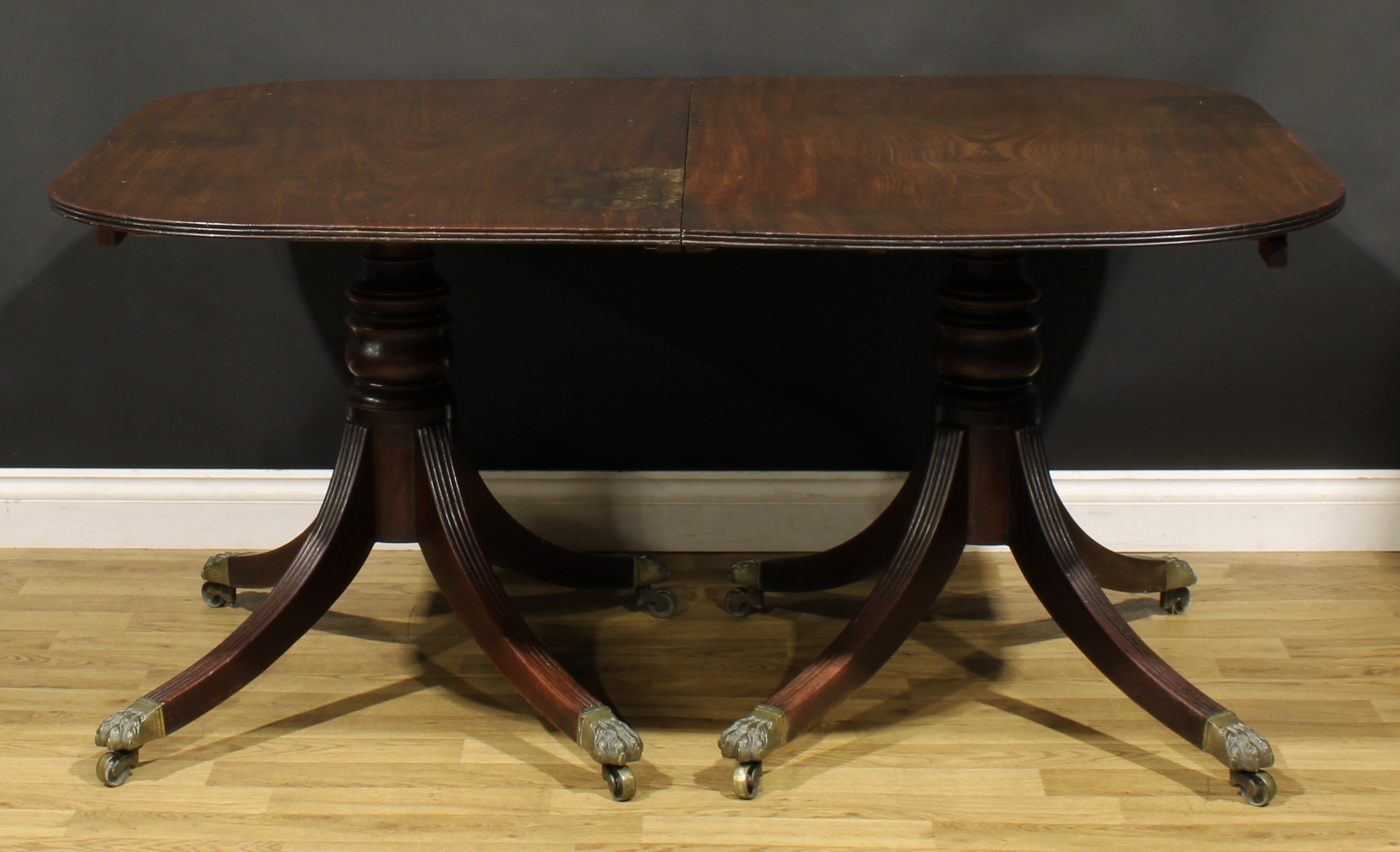 A Regency mahogany twin pillar dining table, rounded rectangular top with reeded edge, turned - Image 2 of 2