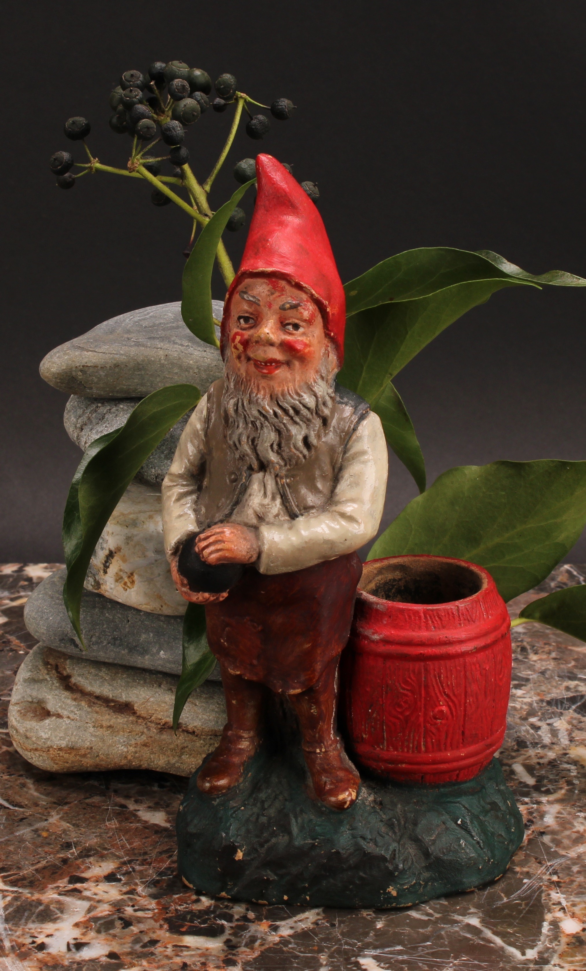 An Austrian terracotta gnome, by Johann Maresch, he stands, playing bowls, 23cm high, impressed