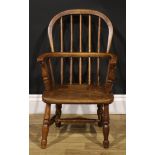 A 19th century ash and elm child’s Windsor elbow chair, 66cm high, 41cm wide