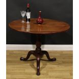 A George III mahogany birdcage tripod supper table, one-piece circular tilting top, baluster column,