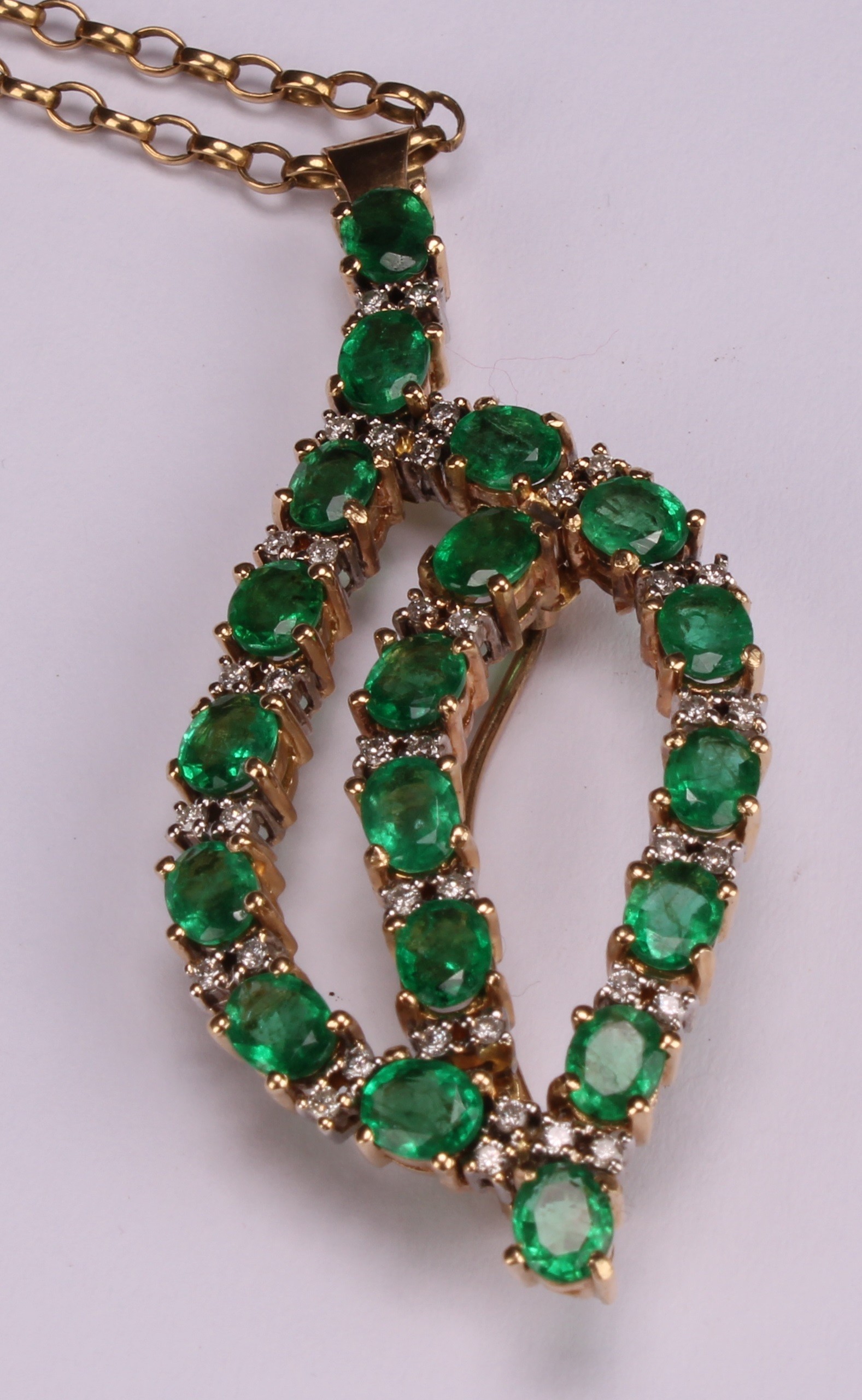 A diamond and emerald pendant brooch, open leaf form set with nineteen oval pale green emeralds, - Image 3 of 4