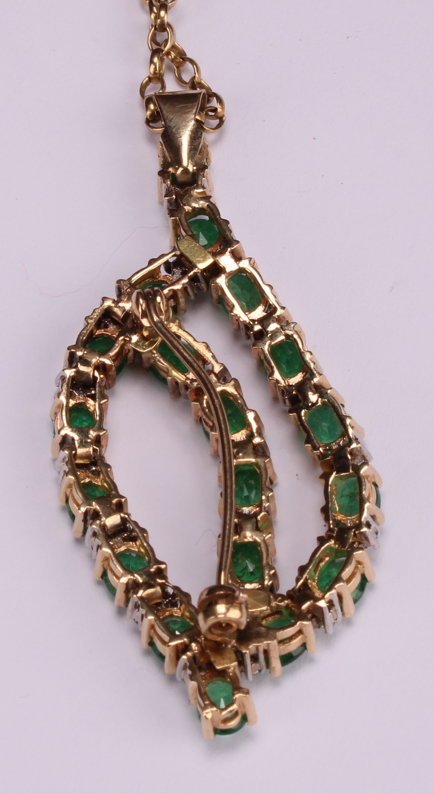 A diamond and emerald pendant brooch, open leaf form set with nineteen oval pale green emeralds, - Image 4 of 4