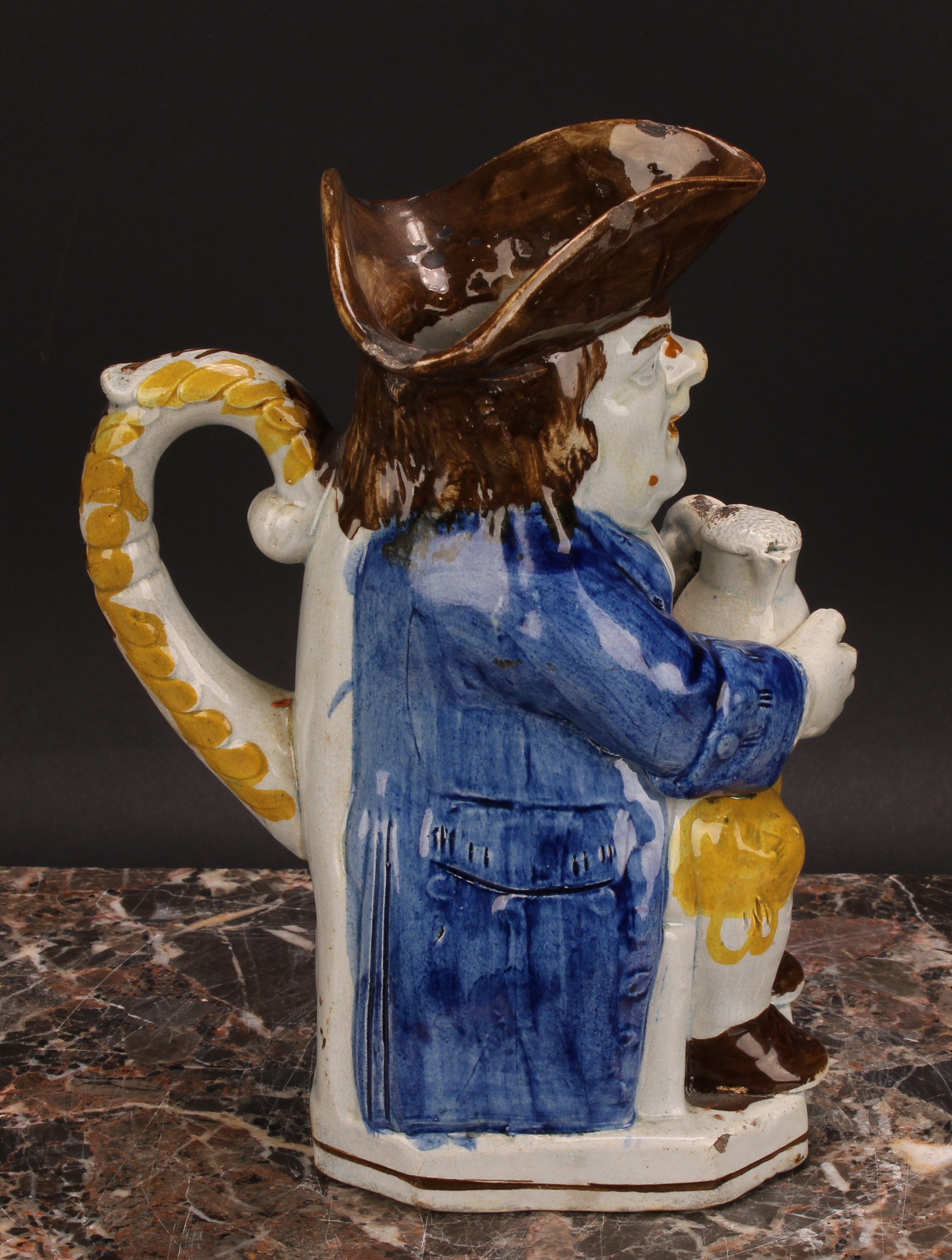 An early 19th century Prattware Toby jug, seated holding a jug of foaming ale, painted in polychrome - Image 3 of 5